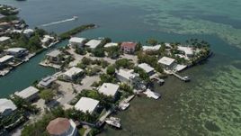5K aerial stock footage of panning across homes along the shore, tilt down, Tavernier, Florida Aerial Stock Footage | AX0025_092