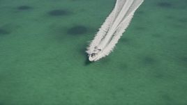 5K aerial stock footage of orbiting a fishing boat speeding across water, Tavernier, Florida Aerial Stock Footage | AX0025_094