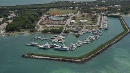 5K aerial stock footage of flying by fishing boats docked, Plantation Yacht Harbor Resort, Islamorada, Florida Aerial Stock Footage | AX0025_103