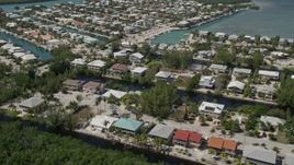 5K aerial stock footage of approaching homes on canals along shore, Islamorada, Florida Aerial Stock Footage | AX0025_104E