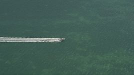 5K aerial stock footage of tracking speedboat off shore of Fat Deer Key, Marathon, Florida Aerial Stock Footage | AX0025_163