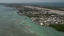 5K aerial stock footage of flying by neighborhoods near Florida Keys Marathon Airport, Marathon, Florida Aerial Stock Footage | AX0025_165E