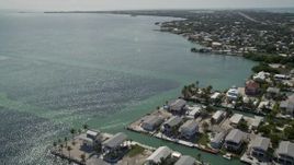 5K aerial stock footage flying over the Atlantic Ocean near homes on the coast, Marathon, Florida Aerial Stock Footage | AX0026_004