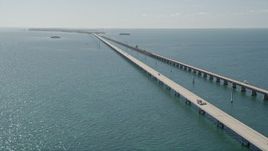 5K aerial stock footage of crossing over the bridge and following light traffic, Seven Mile Bridge, Florida Aerial Stock Footage | AX0026_027E
