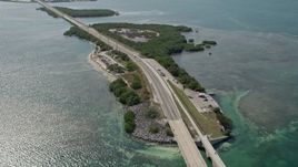 5K aerial stock footage of flying by light traffic, revealing several Keys, Seven Mile Bridge, Florida Aerial Stock Footage | AX0026_032