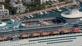 5K aerial stock footage fly by sunbathers at pool on Royal Caribbean Cruise Ship, Key West, Florida Aerial Stock Footage | AX0026_078