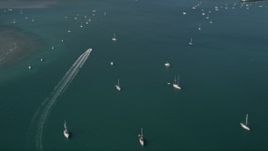 5K aerial stock footage tilt from ocean revealing sailboats moored off the shore of Key West, Florida Aerial Stock Footage | AX0026_082