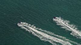5K aerial stock footage of tracking jet skier racing across the ocean in Key West, Florida Aerial Stock Footage | AX0026_089E