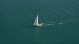 5K aerial stock footage of following a sailboat near the shore of Key West, Florida Aerial Stock Footage | AX0026_096E