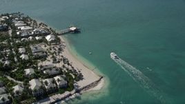 5K aerial stock footage of a ferry nearing a pier on Sunset Key by Key West, Florida Aerial Stock Footage | AX0026_102