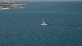 5K aerial stock footage of flying by a catamaran near the shore of Key West, Florida Aerial Stock Footage | AX0026_107
