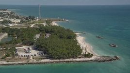 5K aerial stock footage video of flying by sunbathers by Fort Zachary Taylor Historic State Park, Key West, Florida Aerial Stock Footage | AX0026_109