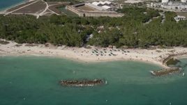 5K aerial stock footage of sunbathers by Fort Zachary Taylor Historic State Park, Key West, Florida Aerial Stock Footage | AX0026_110