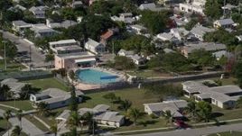 5K aerial stock footage of flying by a large pool behind a house on Key West, Florida Aerial Stock Footage | AX0026_113