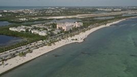5K aerial stock footage of sunbathers on Smathers Beach, Sheraton Suites Key West in Key West, Florida Aerial Stock Footage | AX0026_118