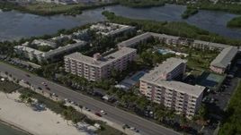 5K aerial stock footage of following coast toward apartment buildings, Sheraton Suites, Key West, Florida Aerial Stock Footage | AX0027_005