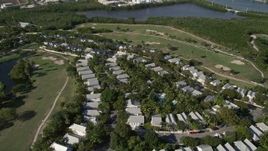 5K aerial stock footage of flying by neighborhood, Key West Golf Club, Stock Island, Key West, Florida Aerial Stock Footage | AX0027_032