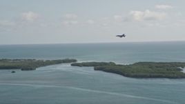 5K aerial stock footage of tracking an F-18 landing at Naval Air Station Key West, Key West, Florida Aerial Stock Footage | AX0027_036