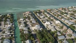 5K aerial stock footage of flying over homes on canals, Big Coppitt Key, Florida Aerial Stock Footage | AX0027_042
