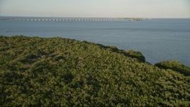 5K aerial stock footage of flying over mangroves, revealing Overseas Highway bridge, Long Key, Florida, sunset Aerial Stock Footage | AX0028_017E