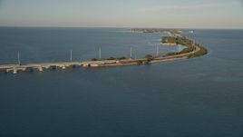 5K aerial stock footage of flying over Atlantic Ocean, revealing Overseas Highway at sunset, Craig Key, Florida Aerial Stock Footage | AX0028_020