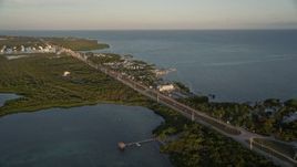 5K aerial stock footage of Overseas Highway by Drop Anchor Resort and Marina, Islamorada, Florida, at sunset Aerial Stock Footage | AX0028_023