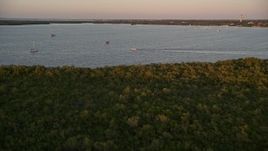 5K aerial stock footage of flying over mangroves, approaching sailboats and fishing boat at sunset, Key Largo, Florida Aerial Stock Footage | AX0028_033