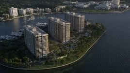 5K aerial stock footage flyby condominium complexes on Grove Isle, Florida, sunrise Aerial Stock Footage | AX0029_008