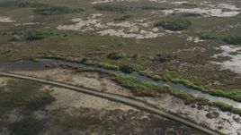 5K aerial stock footage of flying by country road and marshland, Florida Everglades, Florida Aerial Stock Footage | AX0030_058