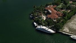 5K aerial stock footage of flying by mansion, yacht docked in front, Coral Gables, Florida Aerial Stock Footage | AX0031_009