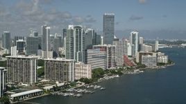 5K aerial stock footage of flying by condo complexes near the Four Seasons on the shore, Miami, Florida Aerial Stock Footage | AX0031_020E