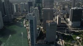 5K aerial stock footage fly by skyscrapers, InterContinental Miami hotel, Miami River, Downtown Miami, Florida Aerial Stock Footage | AX0031_038