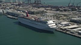5K aerial stock footage of flying by a Carnival Cruise Ship at Port of Miami, Florida Aerial Stock Footage | AX0031_041