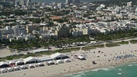 5K aerial stock footage of flying by sunbathers on the beach, South Beach, Miami Beach, Florida Aerial Stock Footage | AX0031_053
