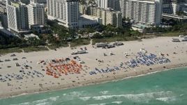5K aerial stock footage of flying by sunbathers, South Beach, Miami Beach, Florida Aerial Stock Footage | AX0031_054