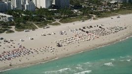 5K aerial stock footage of flying by sunbathers, South Beach, Miami Beach, Florida Aerial Stock Footage | AX0031_055