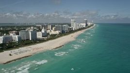 5K aerial stock footage of following the coast and beach lined with hotels, Miami Beach, Florida Aerial Stock Footage | AX0031_057