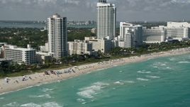 5K aerial stock footage of flying by the beach near Fontainebleau Miami Beach, Miami Beach, Florida Aerial Stock Footage | AX0031_058