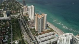 5K aerial stock footage of approaching condominium complex on shore, tilt down, Sunny Isles Beach, Florida Aerial Stock Footage | AX0031_085