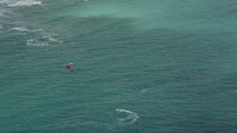 5K aerial stock footage track a kite surfer near the coast, Hollywood, Florida Aerial Stock Footage | AX0031_097