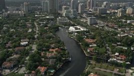 5K aerial stock footage of following New River past mansions, revealing Downtown Fort Lauderdale, Florida Aerial Stock Footage | AX0031_113