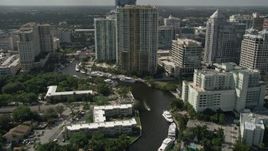 5K aerial stock footage of following New River past mansions, revealing Downtown Fort Lauderdale skyscraper, Florida Aerial Stock Footage | AX0031_114E