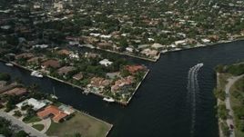 5K aerial stock footage of following canal, tilt down on mansions, Fort Lauderdale, Florida Aerial Stock Footage | AX0031_140