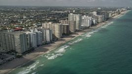 5K aerial stock footage of flying by apartment buildings, revealing beach, coastline, Fort Lauderdale, Florida Aerial Stock Footage | AX0031_143E