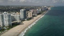 5K aerial stock footage of following the beach past apartment complexes, Lauderdale by the Sea, Florida Aerial Stock Footage | AX0031_149E
