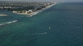 5K aerial stock footage of flying over kite surfers near Hillsboro Inlet Light, Hillsboro Beach, Florida Aerial Stock Footage | AX0031_181