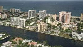 5K aerial stock footage of flying by condominium complexes, approaching the coast, Pompano Beach, Florida Aerial Stock Footage | AX0032_004