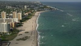 5K aerial stock footage approach Hillsboro Inlet Light, tilt down to sunbathers, Pompano Beach, Florida Aerial Stock Footage | AX0032_006