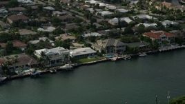 5K aerial stock footage of flying by mansions on the bank of Intracoastal Waterway, Lighthouse Point, Florida Aerial Stock Footage | AX0032_010