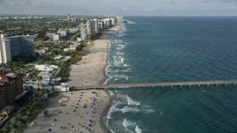 5K aerial stock footage follow the beach, over Deerfield Beach Fishing Pier, Deerfield Beach, Florida Aerial Stock Footage | AX0032_017